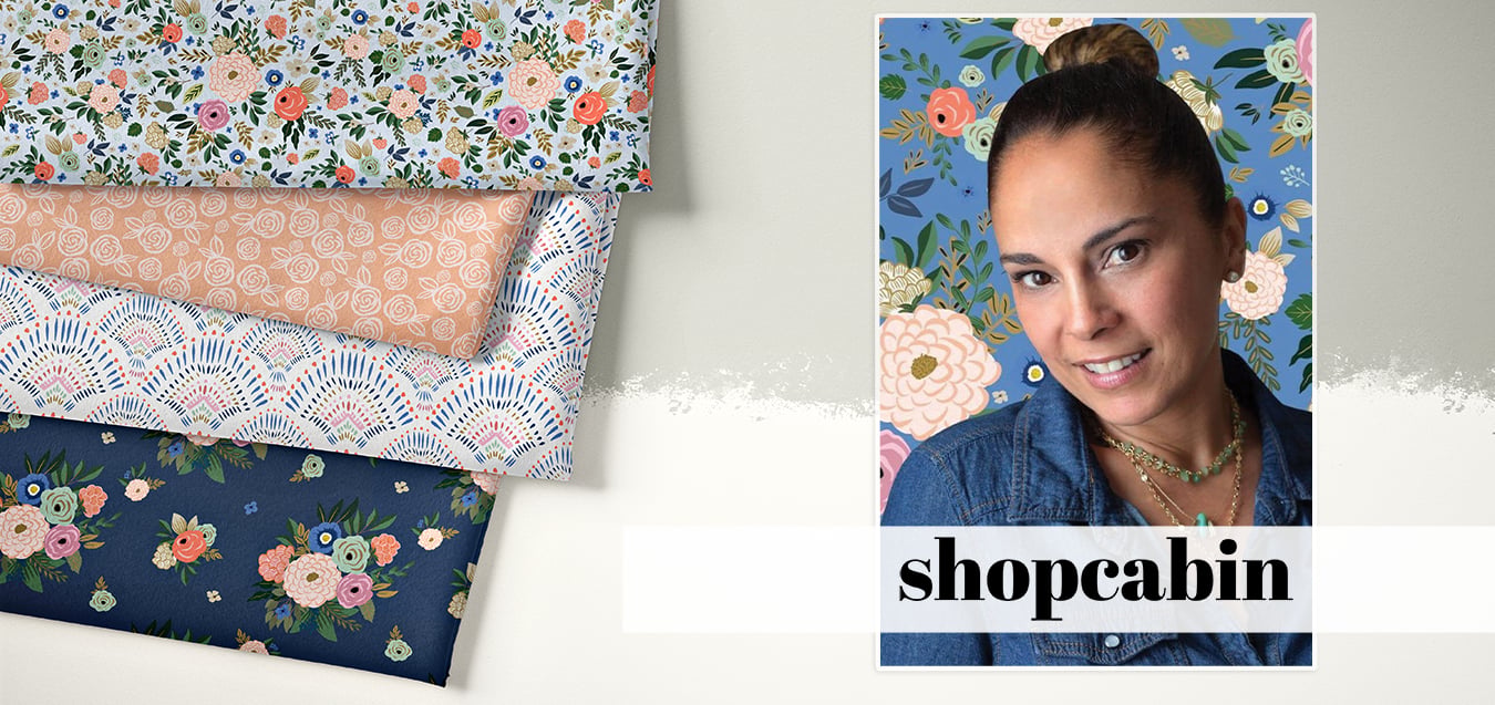Folded floral fabrics in blue, peach, and navy prints beside a portrait of a woman for the Shopcabin brand