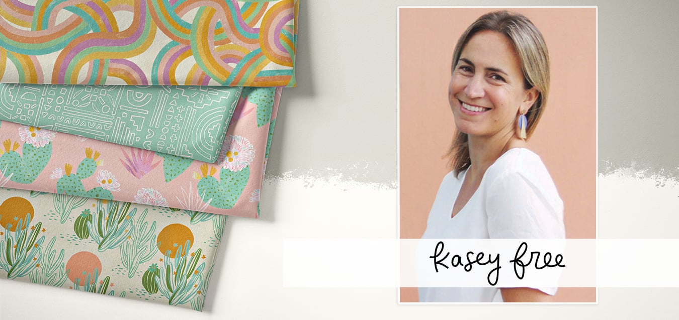 Portrait of designer Kasey Free beside folded fabrics with rainbow swirl, teal geometric, pink floral cactus, and cream desert prints