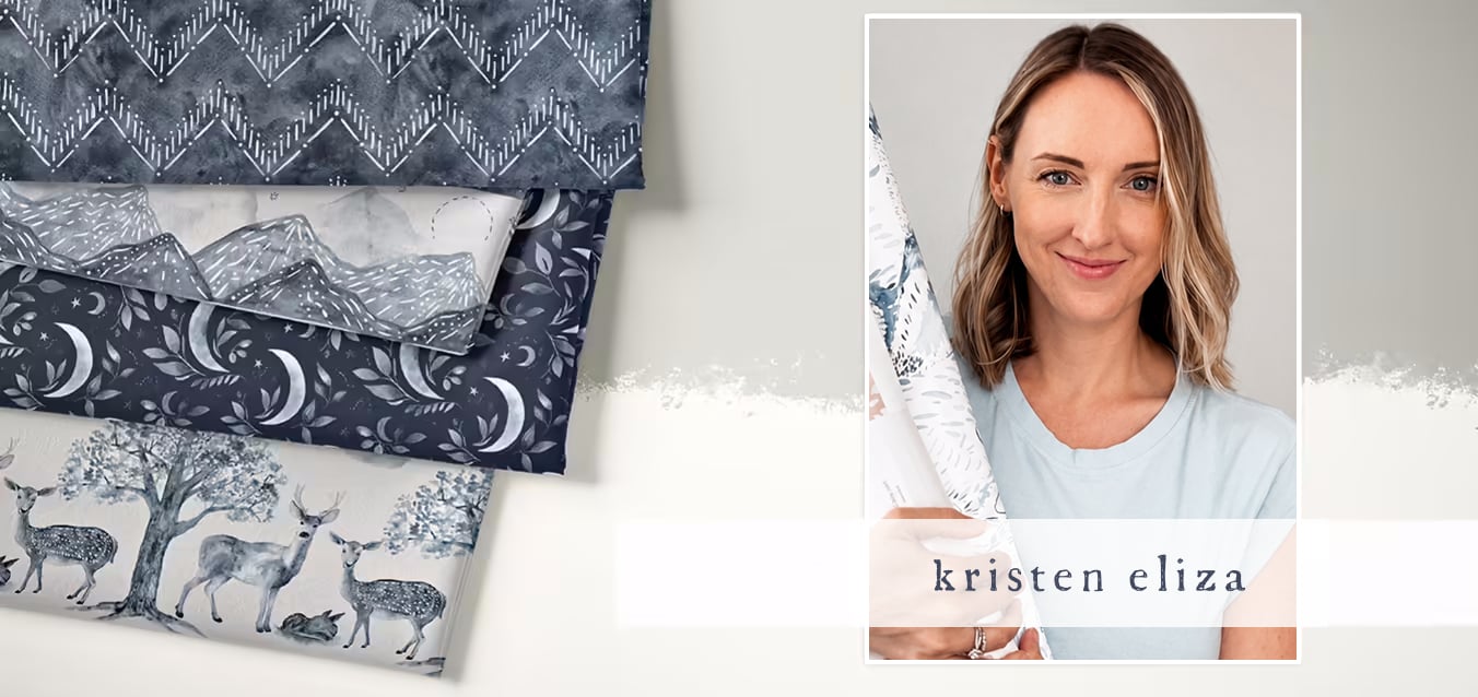 Folded gray-toned fabrics with chevron, mountain, moon and leaf, and forest deer prints, beside a photo of designer Kristen Eliza holding a fabric bolt.