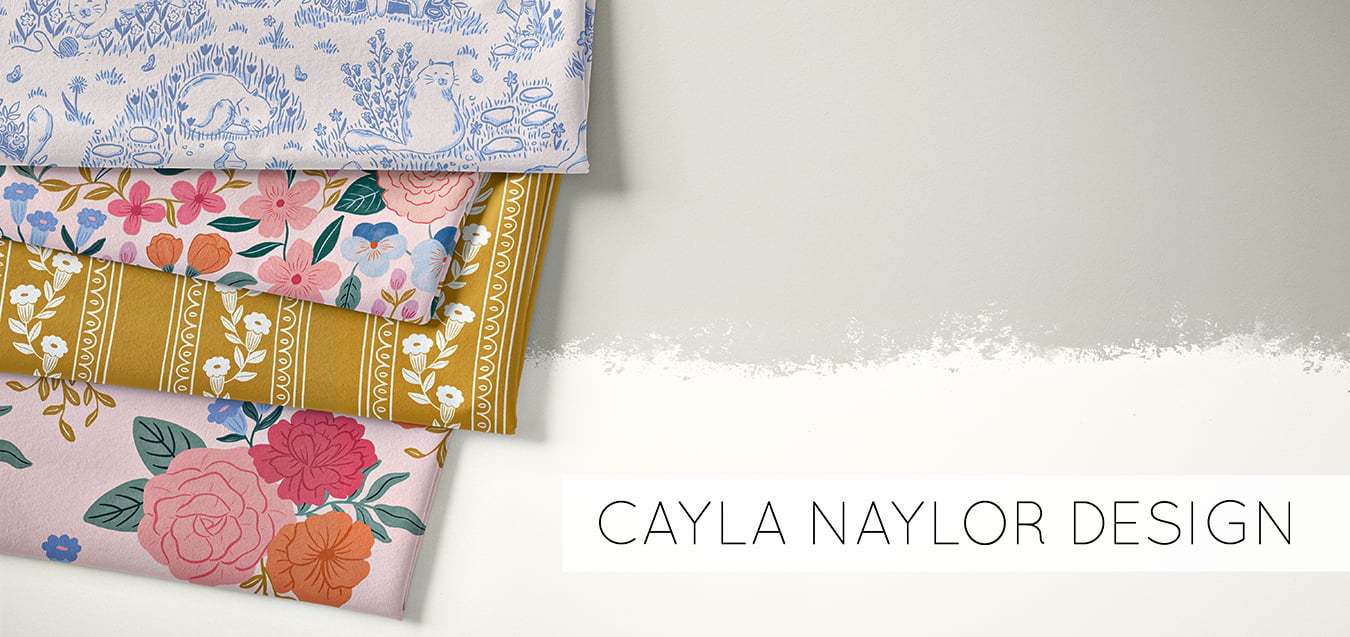 Folded fabrics with blue cat toile, pink floral, mustard floral stripe, and pink rose prints, text reads Cayla Naylor Design