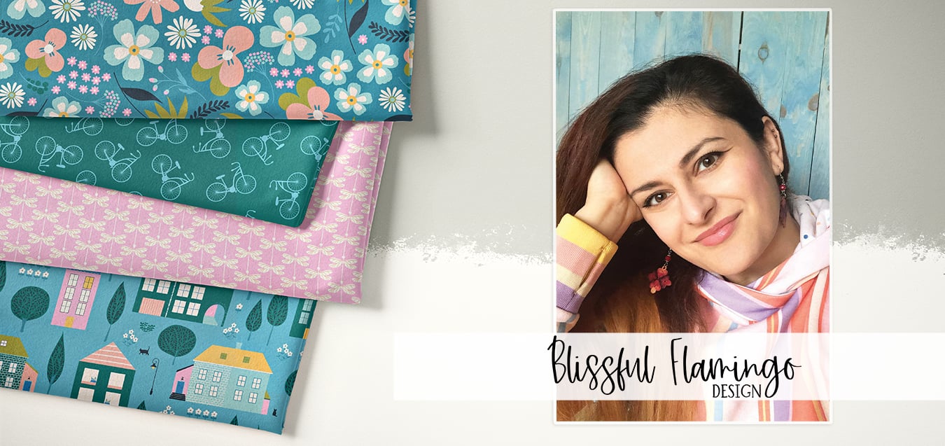 Folded fabrics with floral, bicycle, dragonfly, and house prints beside a portrait of designer Blissful Flamingo