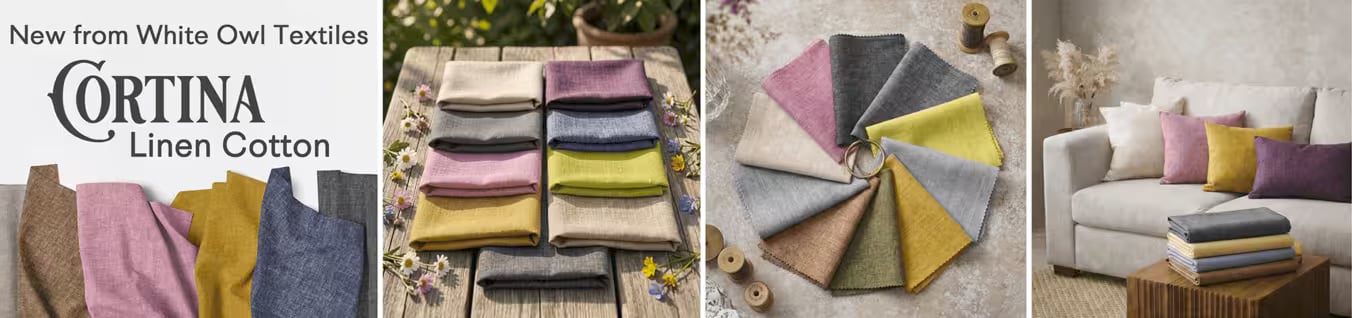 Cortina Linen Cotton fabric swatches in brown, pink, mustard, navy, gray and yellow, folded on a wood table and styled on a sofa with pillows
