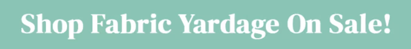 Bold white text reading "Shop Fabric Yardage On Sale!" on a sage green background